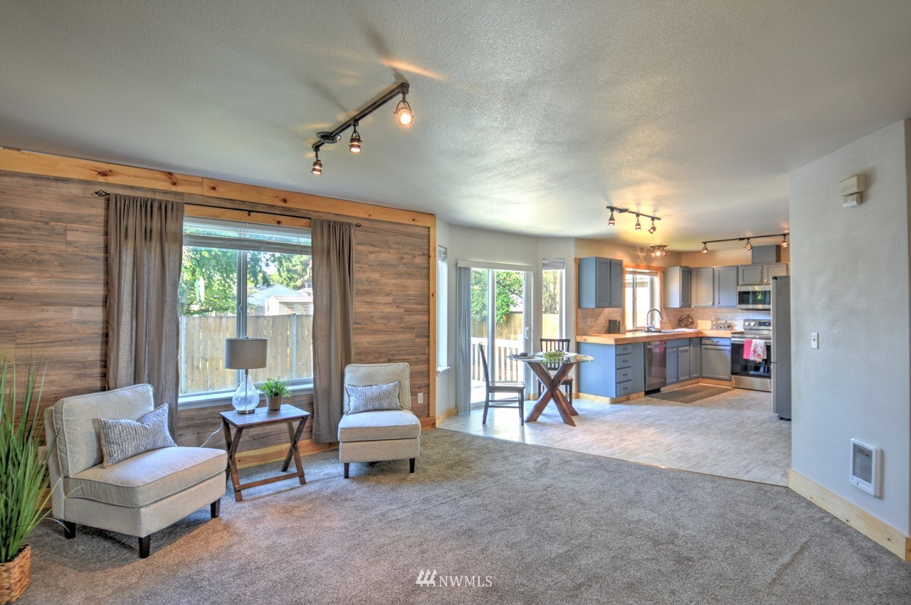 1308 Golf Club Road Southeast Lacey, WA 98503 - Photo 4 of 23 a living room with furniture and a large window
