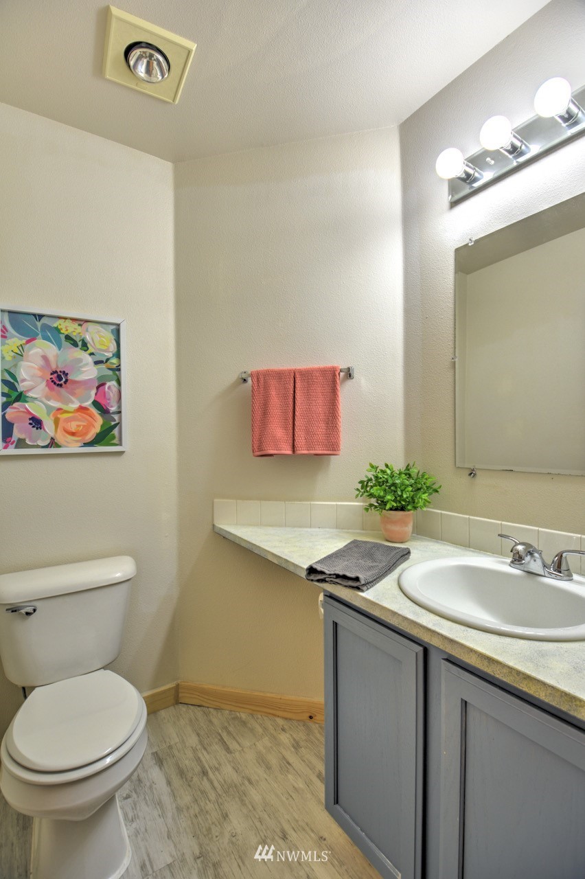 1308 Golf Club Road Southeast Lacey, WA 98503 - Photo 10 of 23 a bathroom with a toilet sink and mirror