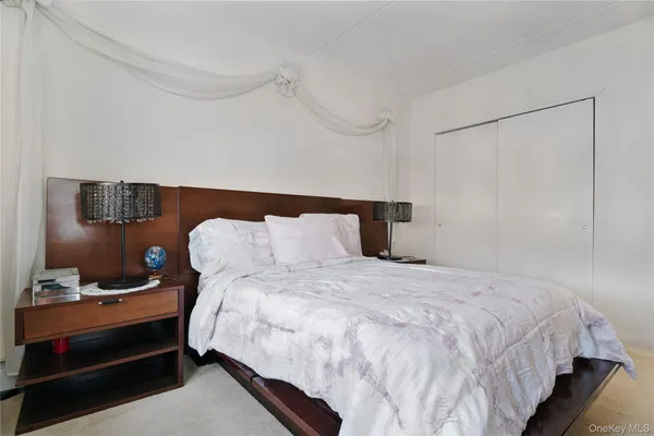 a bedroom with a bed and a night stand