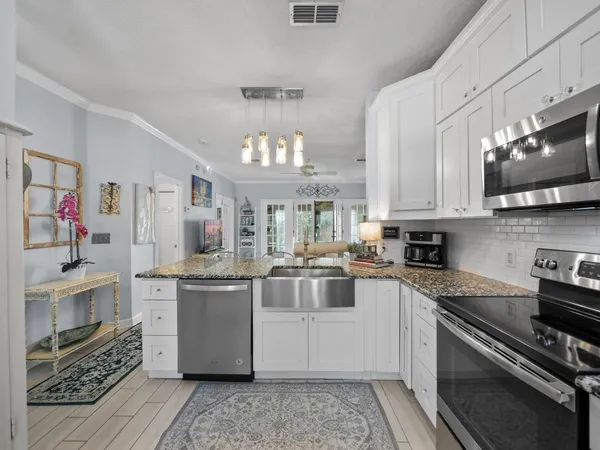 a kitchen with stainless steel appliances granite countertop a stove and a sink