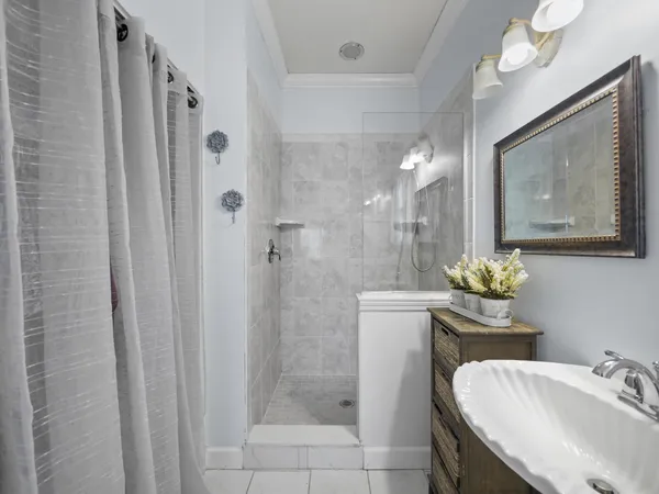 a bathroom with a sink a light fixture and a mirror