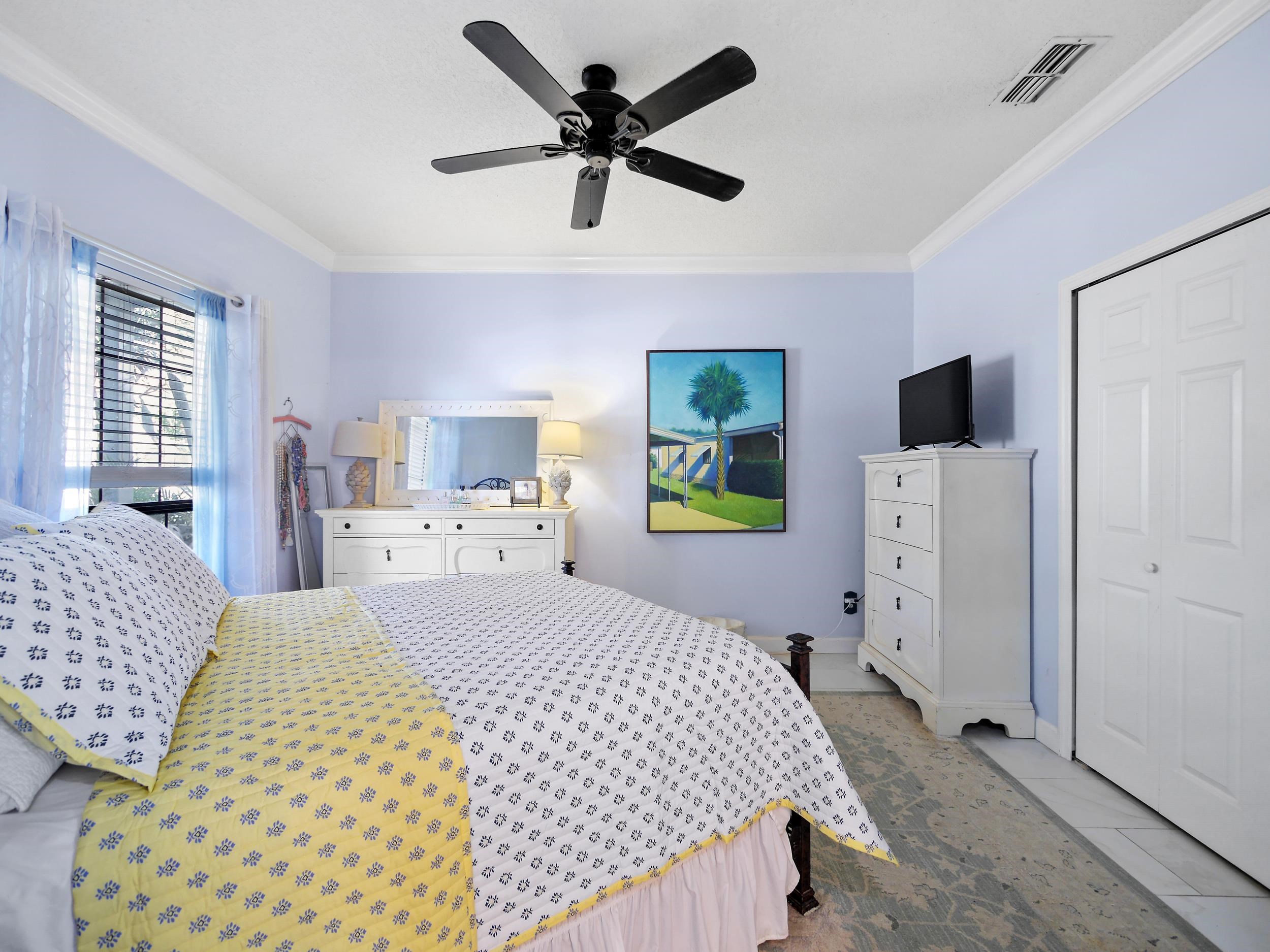 84 Seascape Circle St. Augustine, FL 32080 - Photo 19 of 34 a bedroom with a bed and a flat tv screen on the dresser