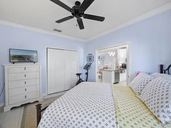 a bedroom with a large bed and a chandelier