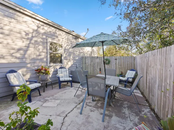a backyard of a house with table and chairs