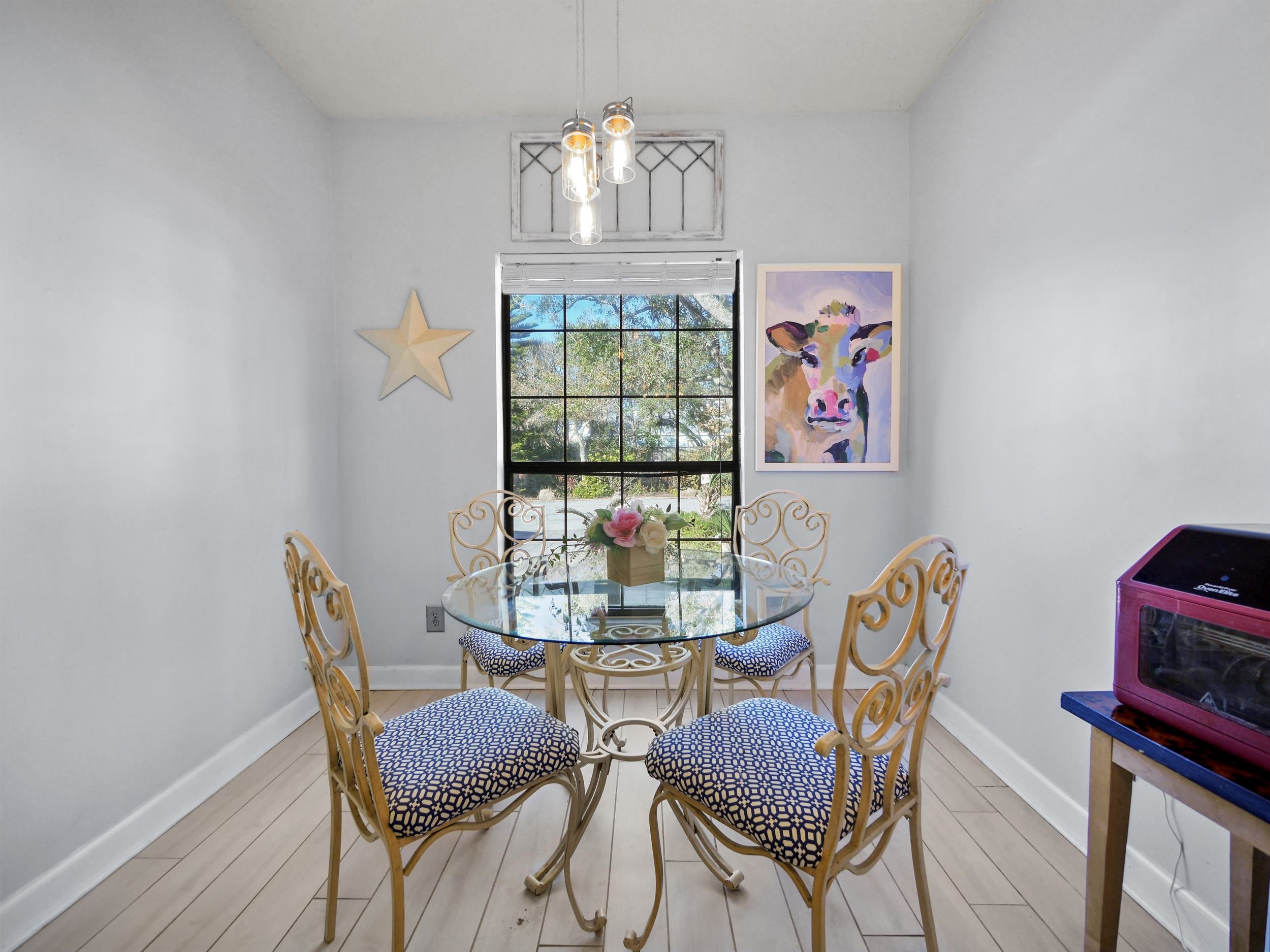 84 Seascape Circle St. Augustine, FL 32080 - Photo 10 of 34 a view of a dining room with furniture a chandelier and wooden floor