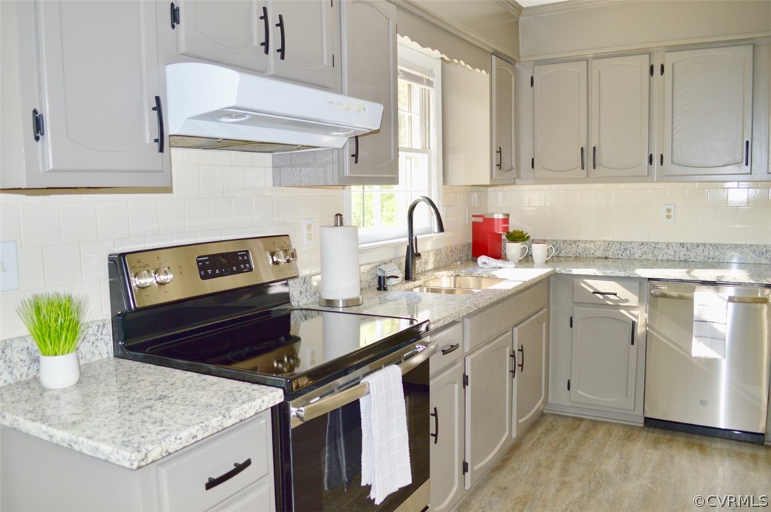 7442 Drexelbrook Road Chesterfield, VA 23832 - Photo 8 of 24 a kitchen with stainless steel appliances granite countertop a sink stove and white cabinets