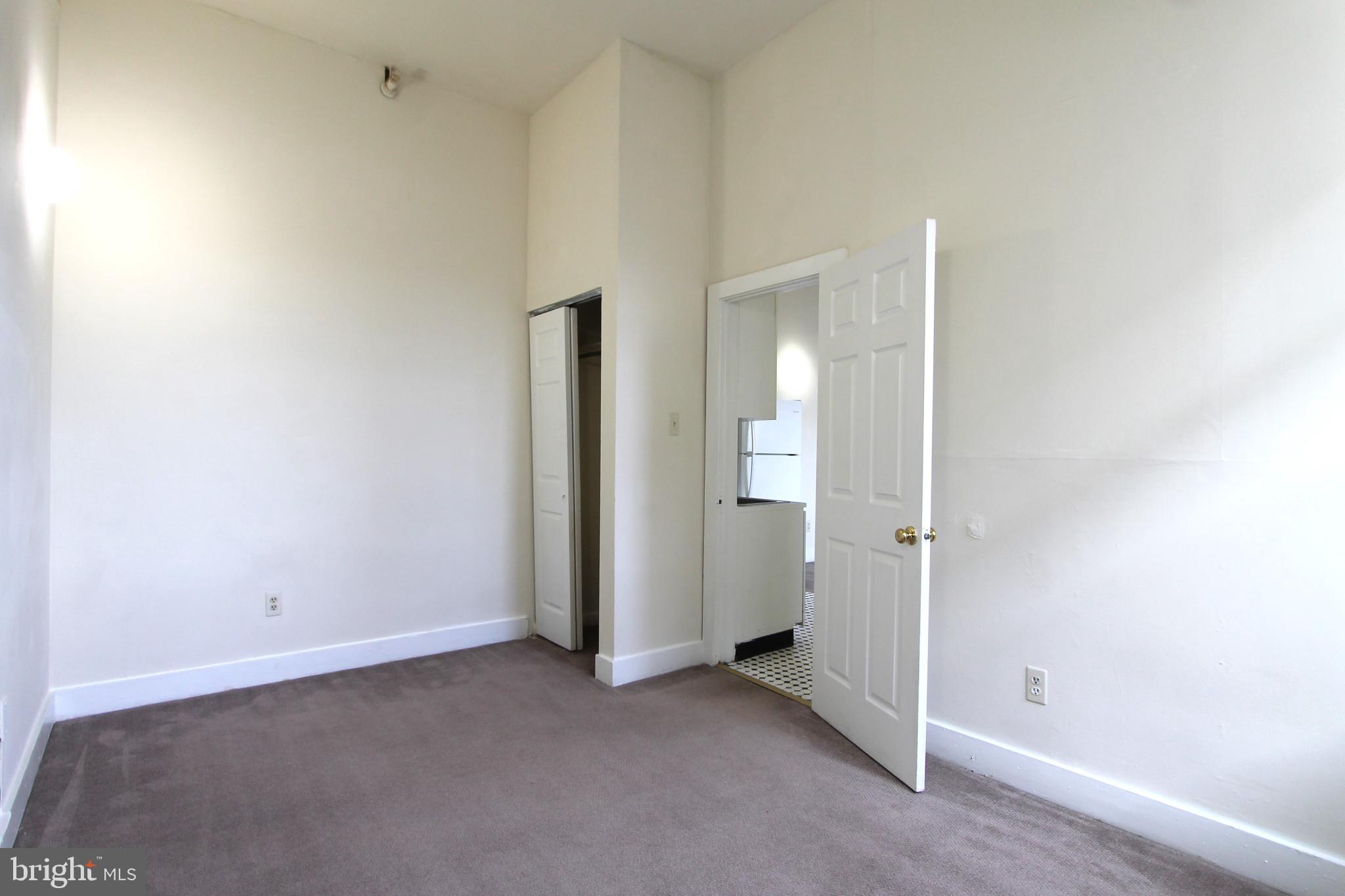 100 East Price Street, Unit 1G Philadelphia, PA 19144 - Photo 12 of 16 an empty room with closet and a bathroom