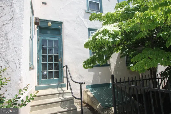 a front view of a building with plants
