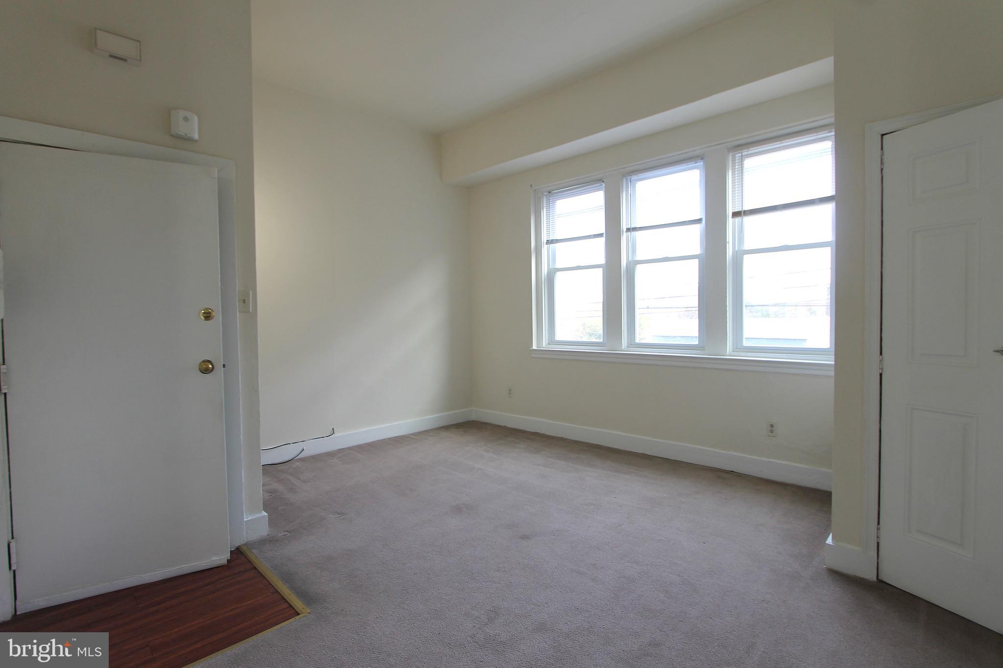 100 East Price Street, Unit 1G Philadelphia, PA 19144 - Photo 2 of 16 a view of an empty room with a window