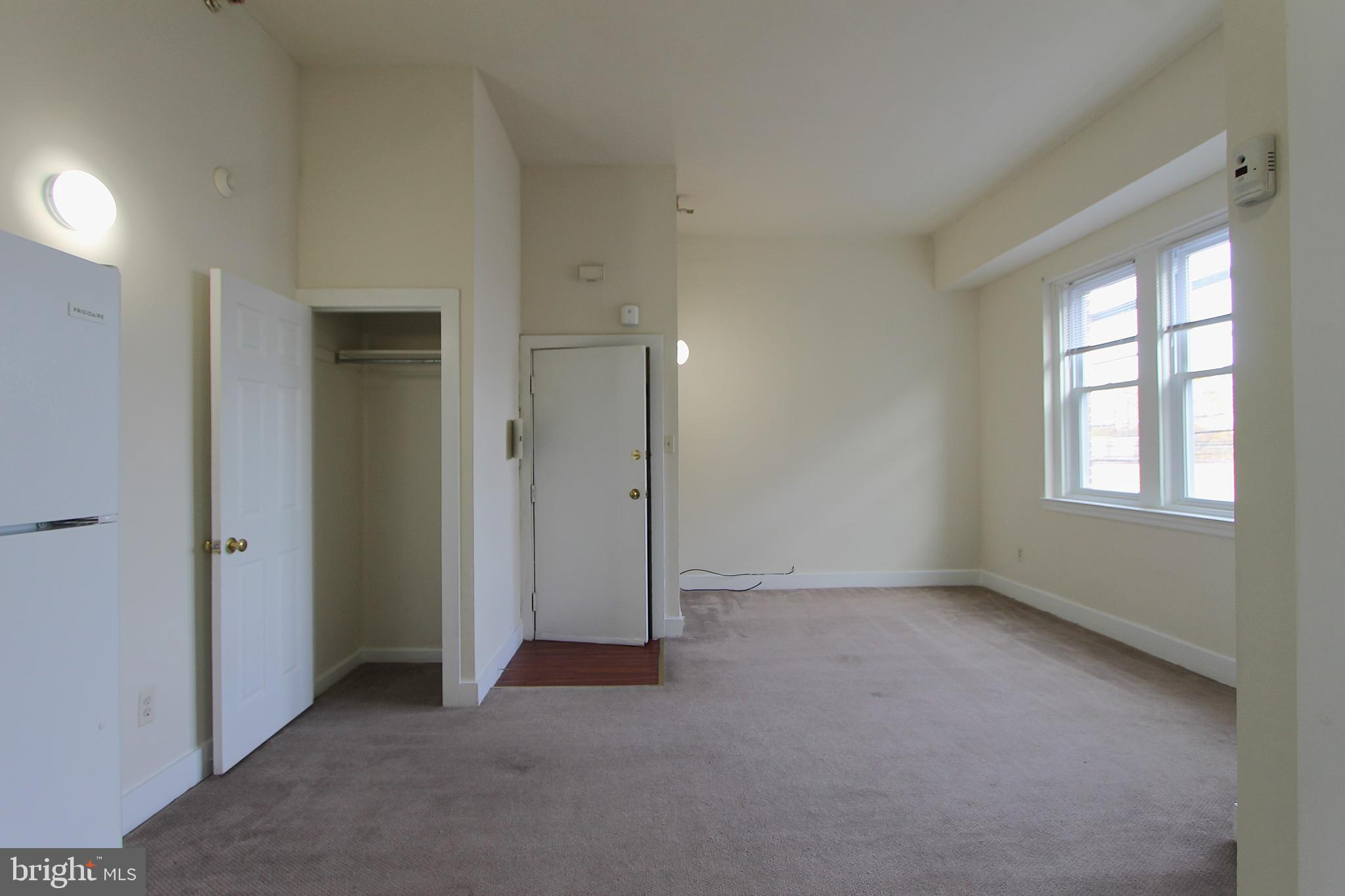 100 East Price Street, Unit 1G Philadelphia, PA 19144 - Photo 3 of 16 an empty room with windows
