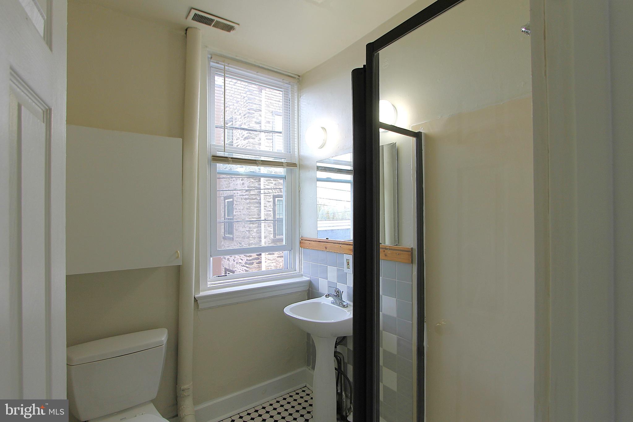 100 East Price Street, Unit 1G Philadelphia, PA 19144 - Photo 5 of 16 a bathroom with a bathtub and a shower