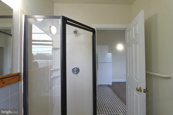 a bathroom with a glass shower door