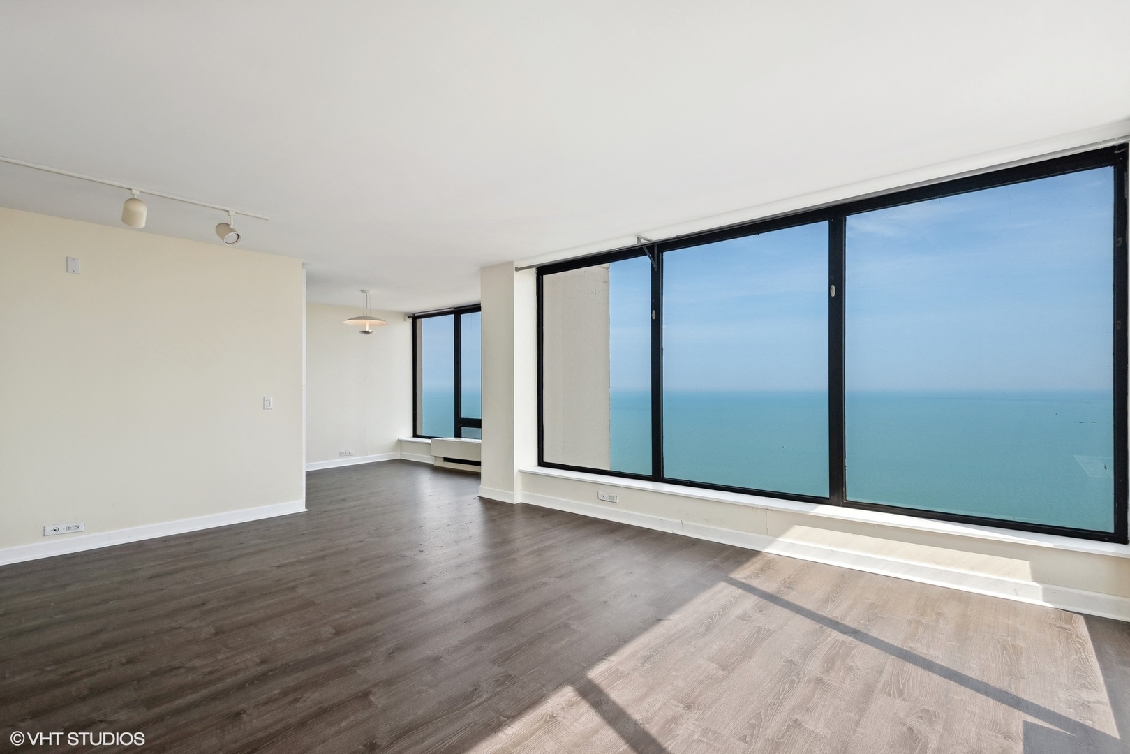 5445 North Sheridan Road, Unit 3812 Chicago, IL 60640 - Photo 4 of 21 a view of an empty room with wooden floor