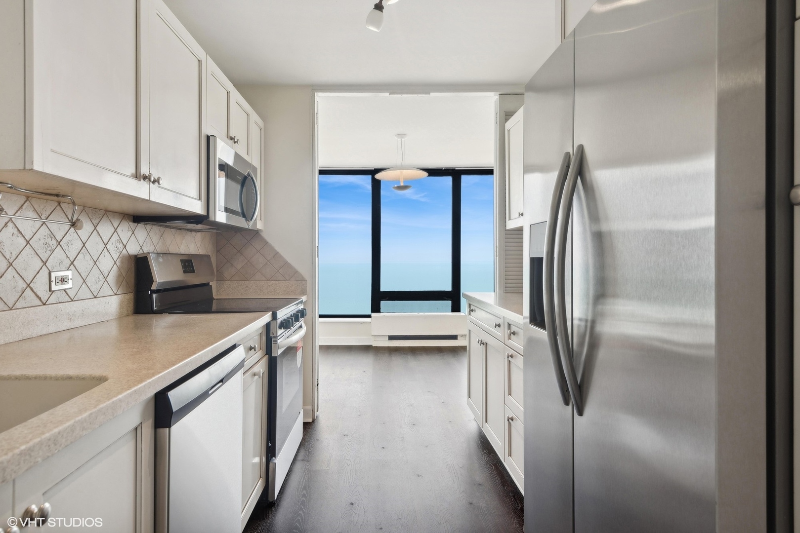 5445 North Sheridan Road, Unit 3812 Chicago, IL 60640 - Photo 6 of 21 a kitchen with stainless steel appliances a refrigerator and a sink