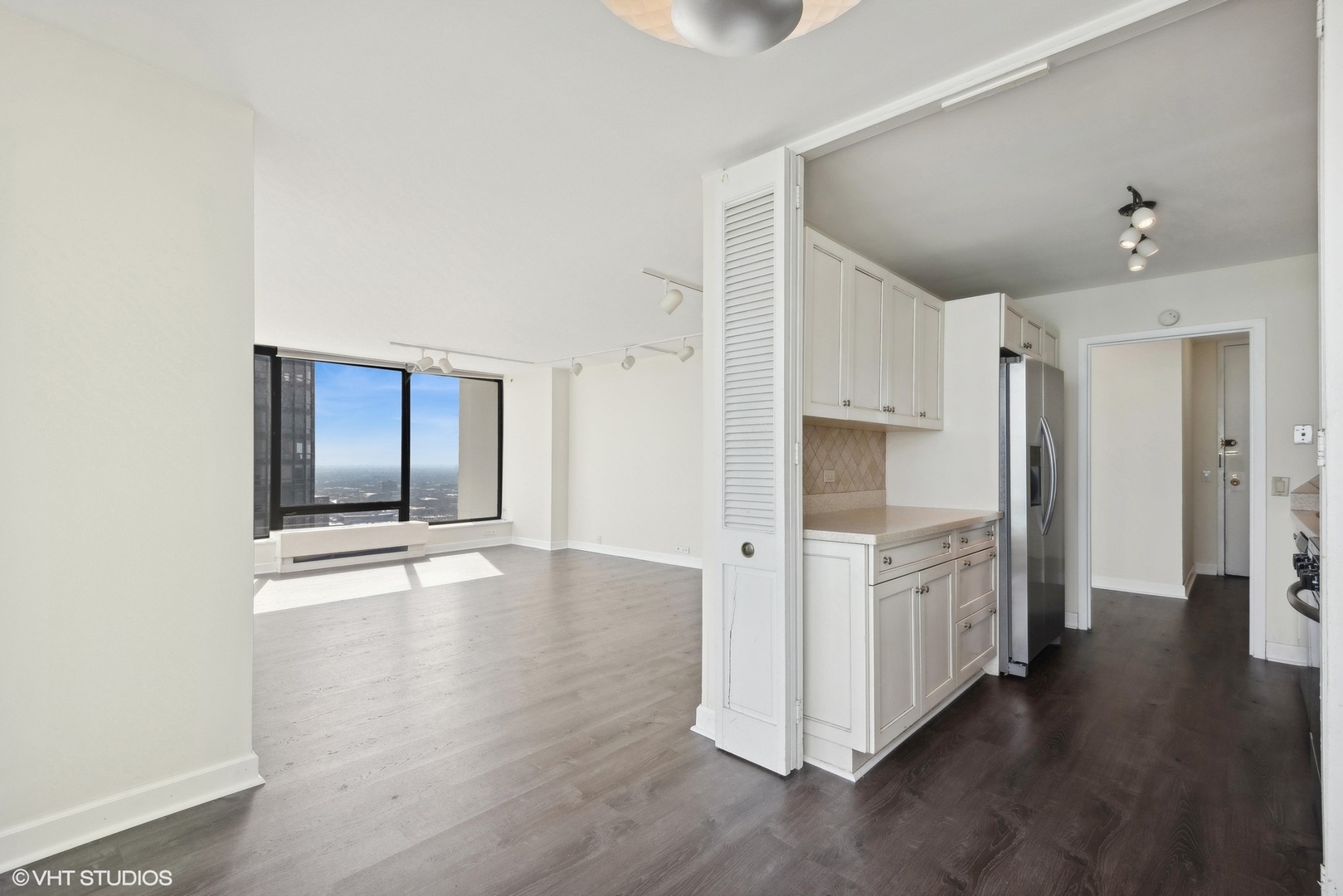 5445 North Sheridan Road, Unit 3812 Chicago, IL 60640 - Photo 9 of 21 a view of a hallway with wooden floor and cabinets