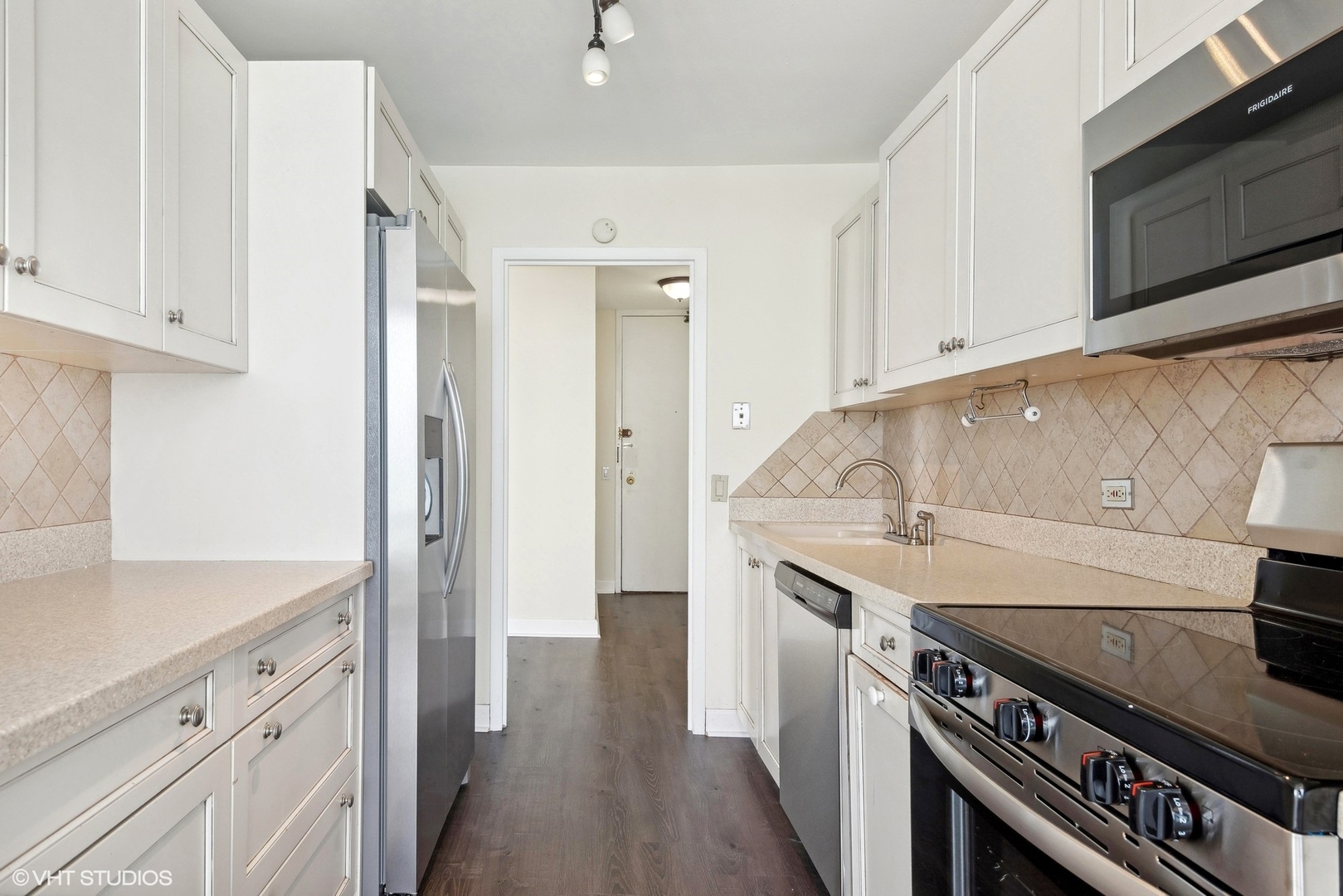 5445 North Sheridan Road, Unit 3812 Chicago, IL 60640 - Photo 10 of 21 a kitchen with a sink stove and cabinets