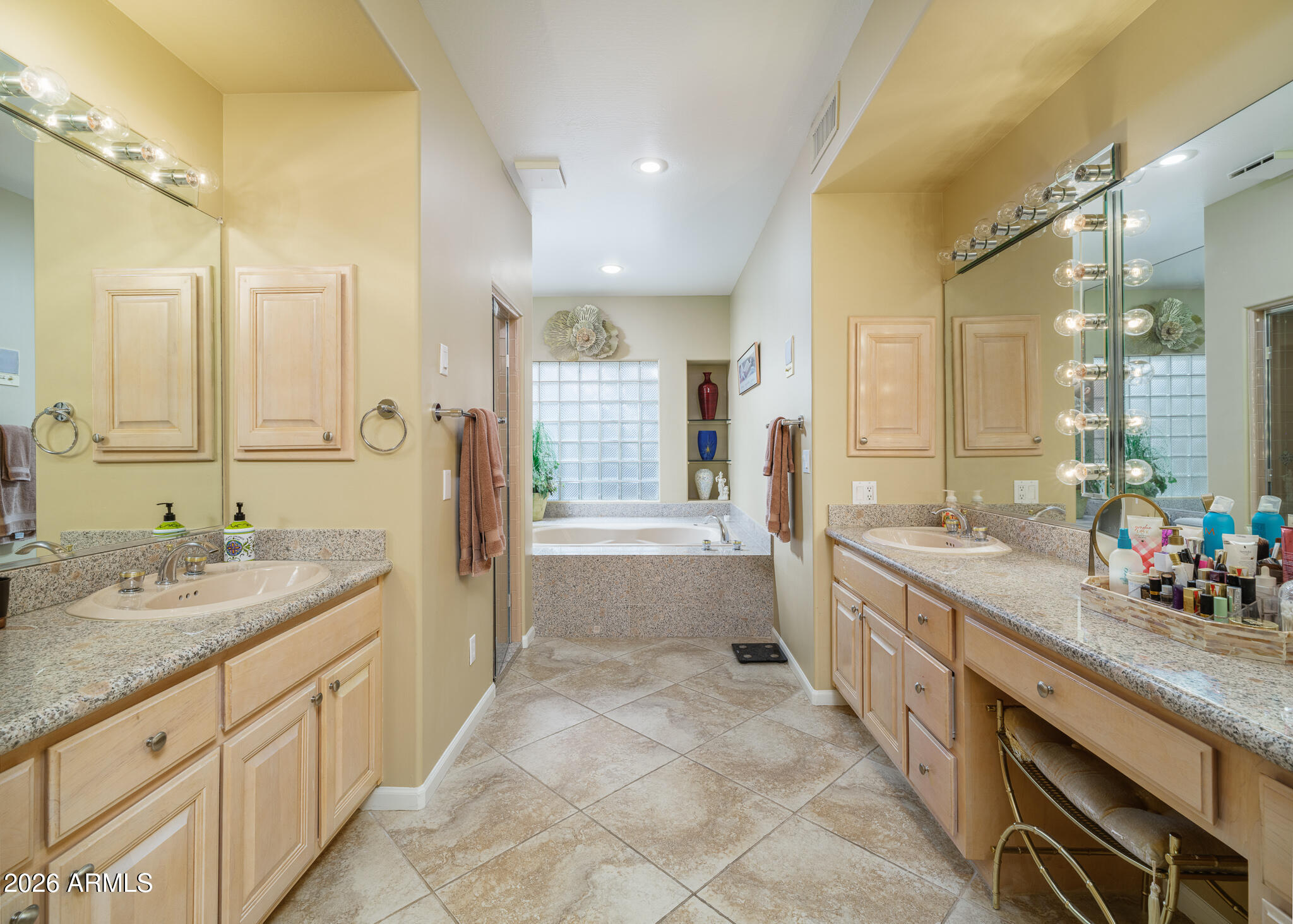 2329 East Hatcher Road Phoenix, AZ 85028 - Photo 20 of 40 a spacious bathroom with a granite countertop sink a mirror a bathtub and shower
