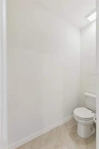 a white toilet sitting next to a white sink