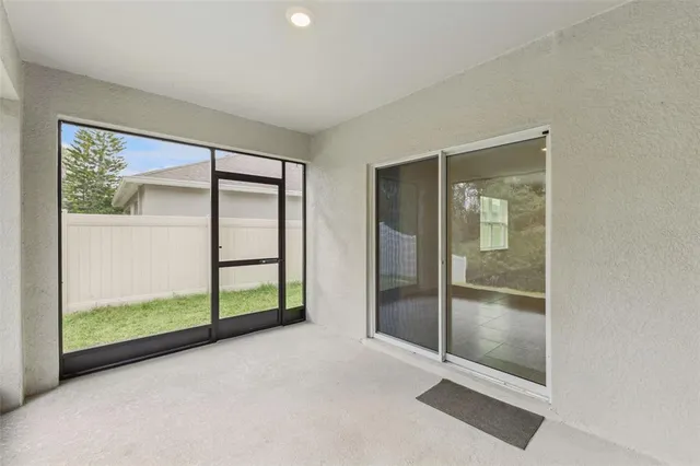 an empty room with sliding glass door and shower