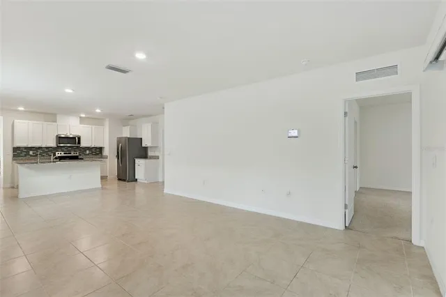 a view of kitchen with refrigerator sink and stove