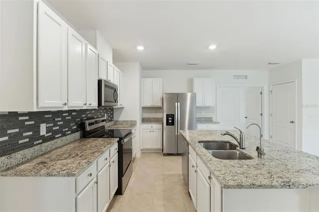 a kitchen with a sink stove and refrigerator