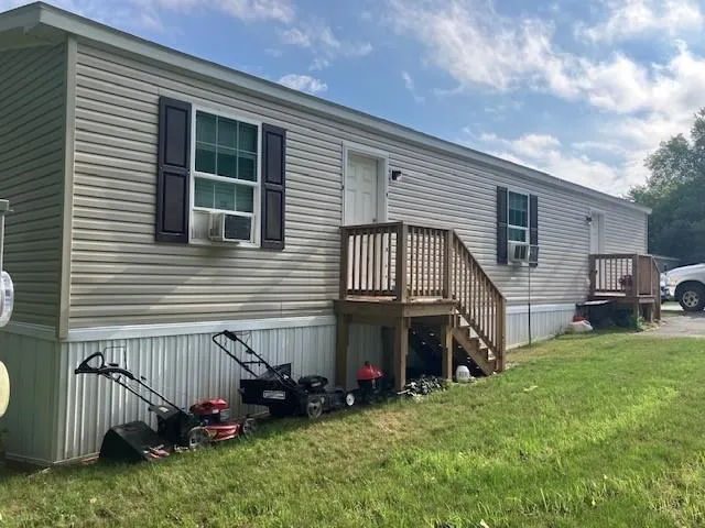 a view of a house with a yard and furniture