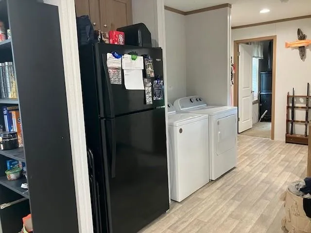 a kitchen with refrigerator a washer and dryer