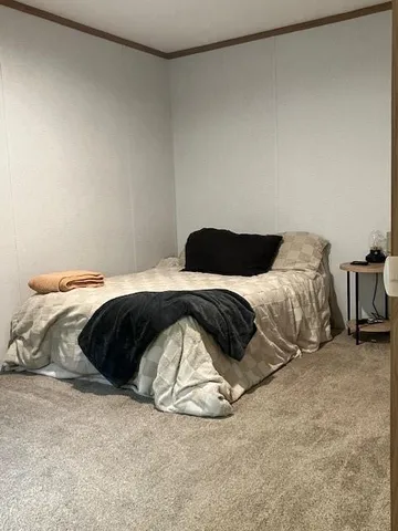a bedroom with a bed and a chair