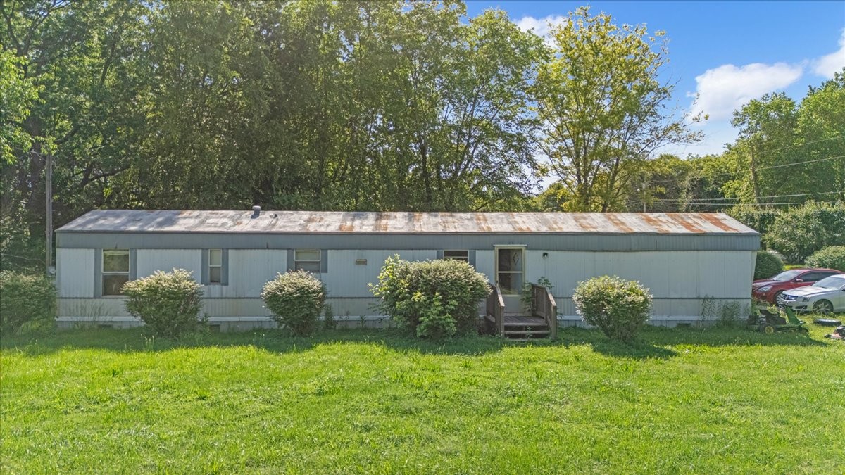 0 Ez Lane Manchester, TN 37355 - Photo 23 of 56 a couple of potted plants sitting in front of a house
