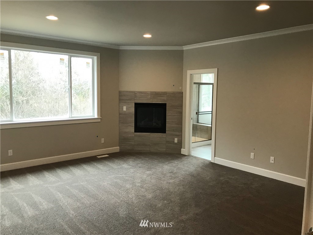 1670 Spaulding Circle Buckley, WA 98321 - Photo 12 of 22 an empty room with windows and fireplace