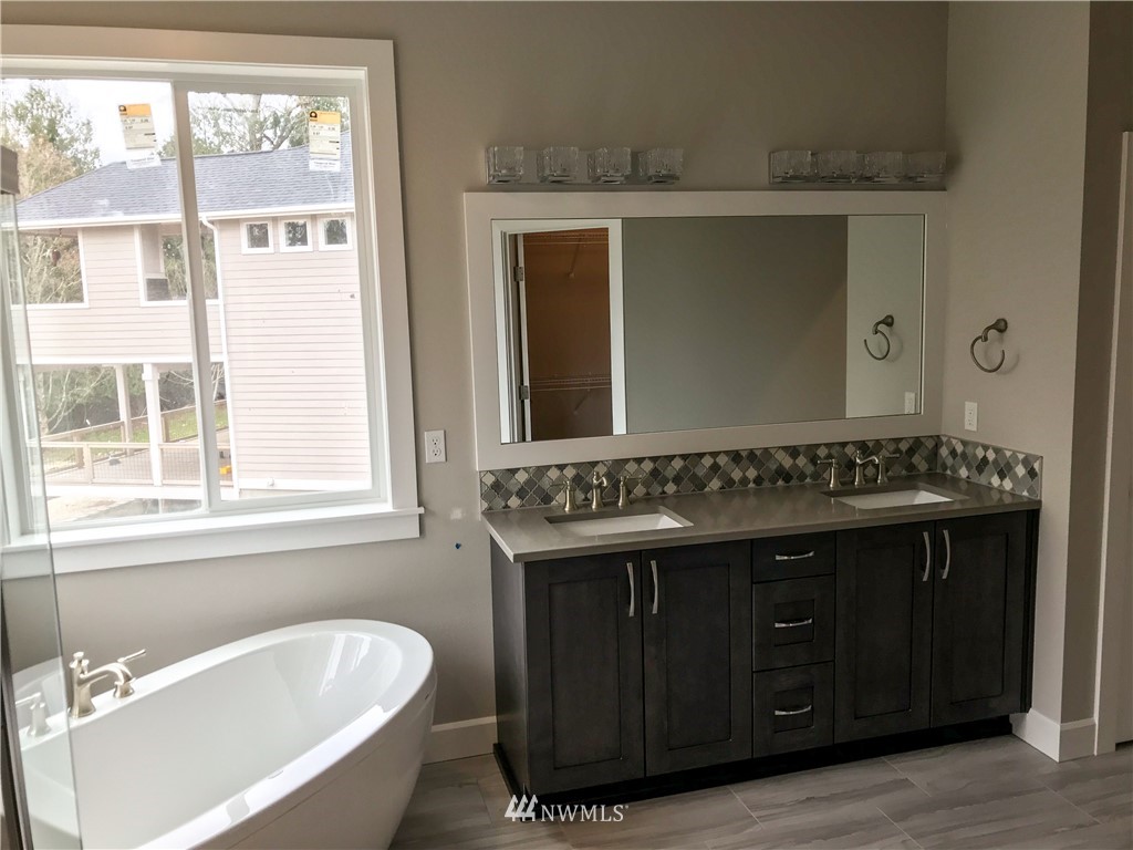 1670 Spaulding Circle Buckley, WA 98321 - Photo 14 of 22 a bathroom with a tub sink and mirror
