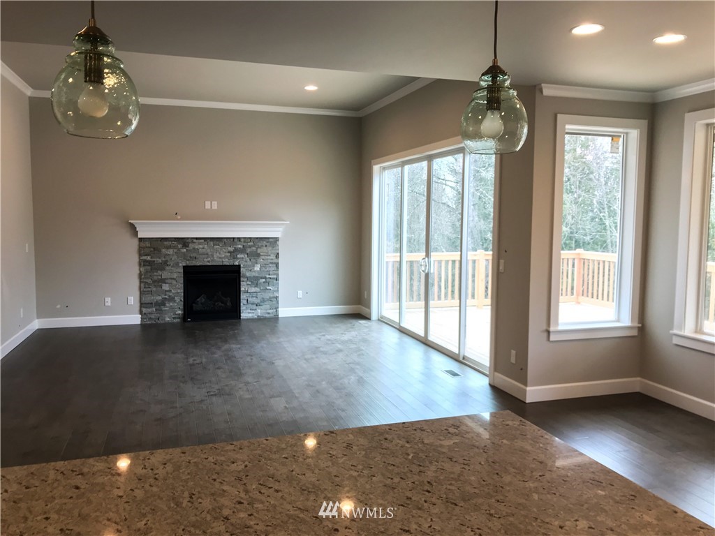 1670 Spaulding Circle Buckley, WA 98321 - Photo 5 of 22 a view of an empty room with wooden floor fireplace and a window