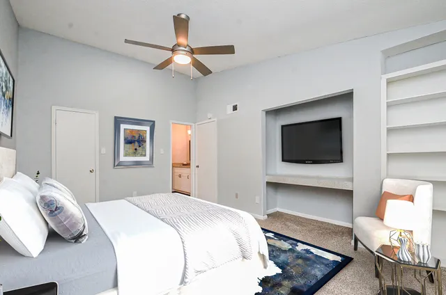 a bedroom with a bed and a flat screen tv