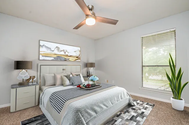 a bedroom with bed and a window