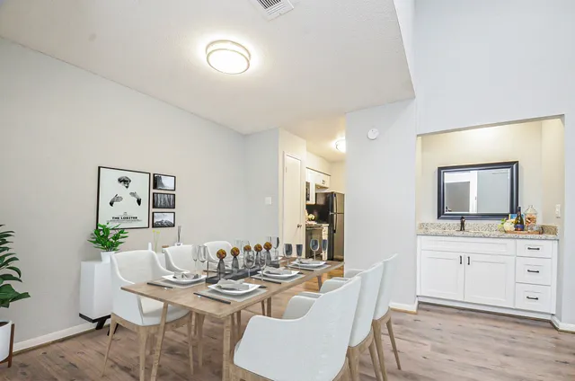 an empty room with windows and fireplace