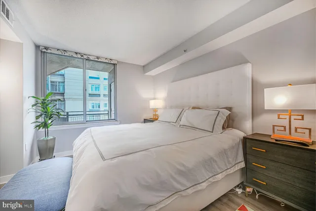 a bedroom with a bed and a lamp