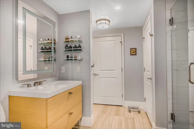 a bathroom with a sink a mirror and shower