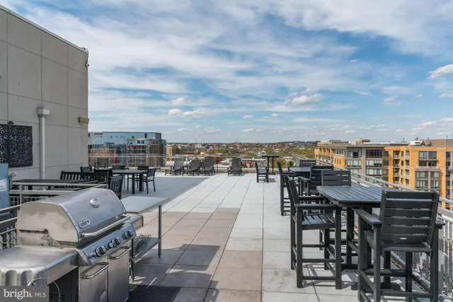 a terrace with outdoor seating city view and barbeque oven