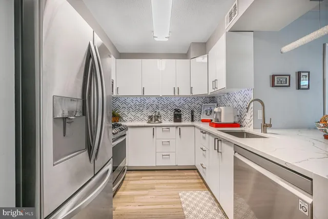 a kitchen with a sink stove and refrigerator
