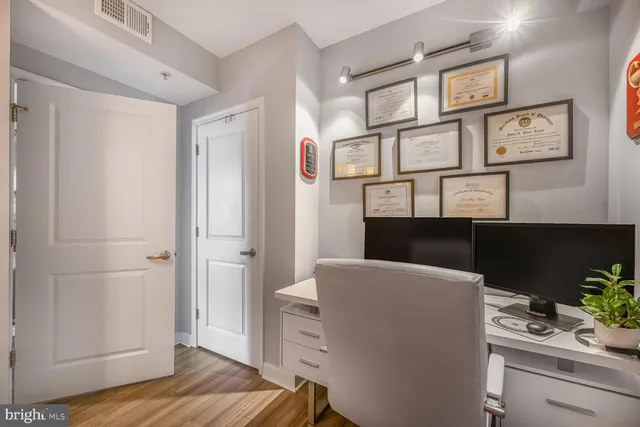 a view of kitchen and hallway with wooden floor
