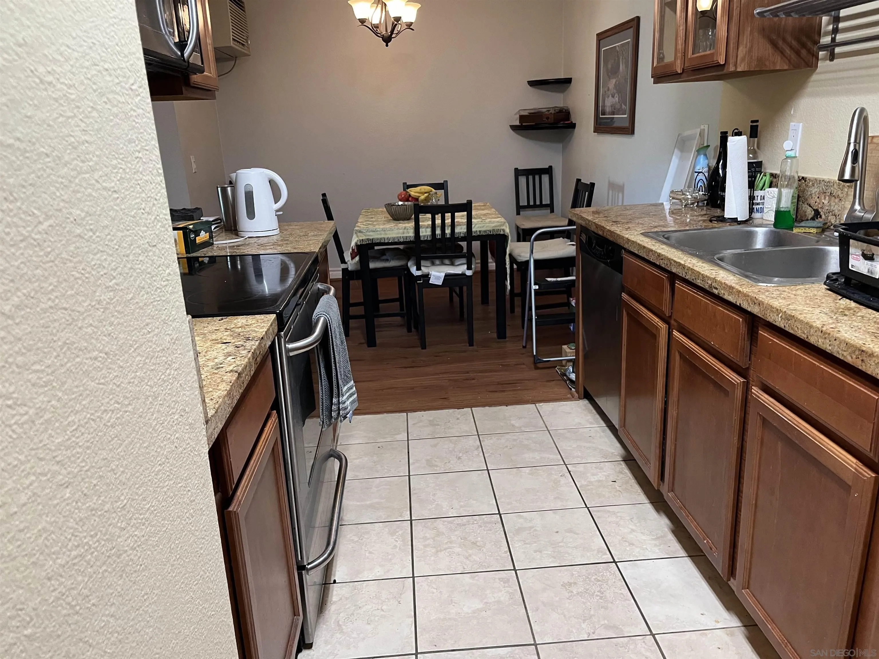 9929 Azuaga Street, Unit F 202 San Diego, CA 92129 - Photo 13 of 18 a kitchen with a sink and cabinets