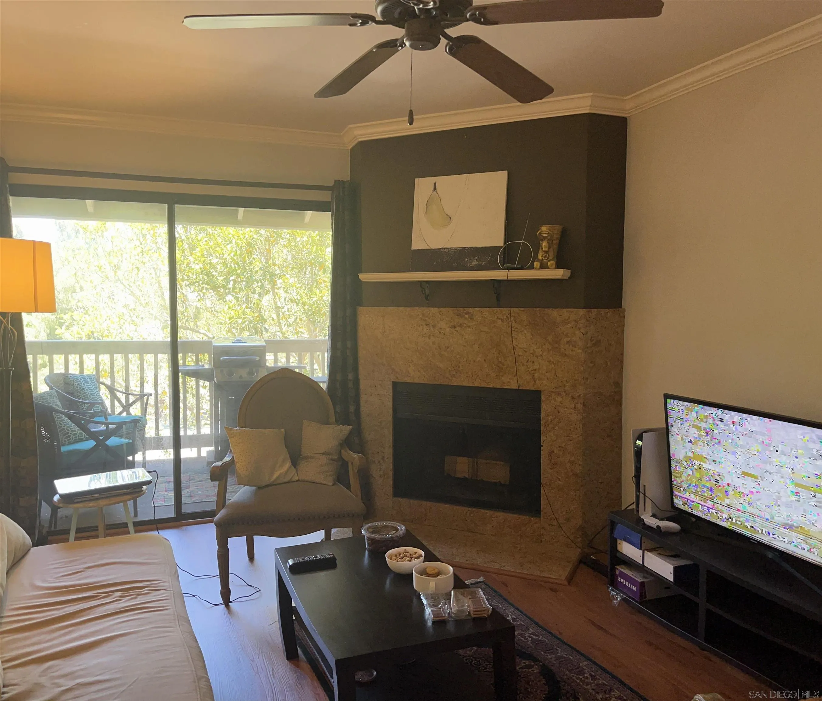 9929 Azuaga Street, Unit F 202 San Diego, CA 92129 - Photo 14 of 18 a living room with furniture a floor to ceiling window and a flat screen tv