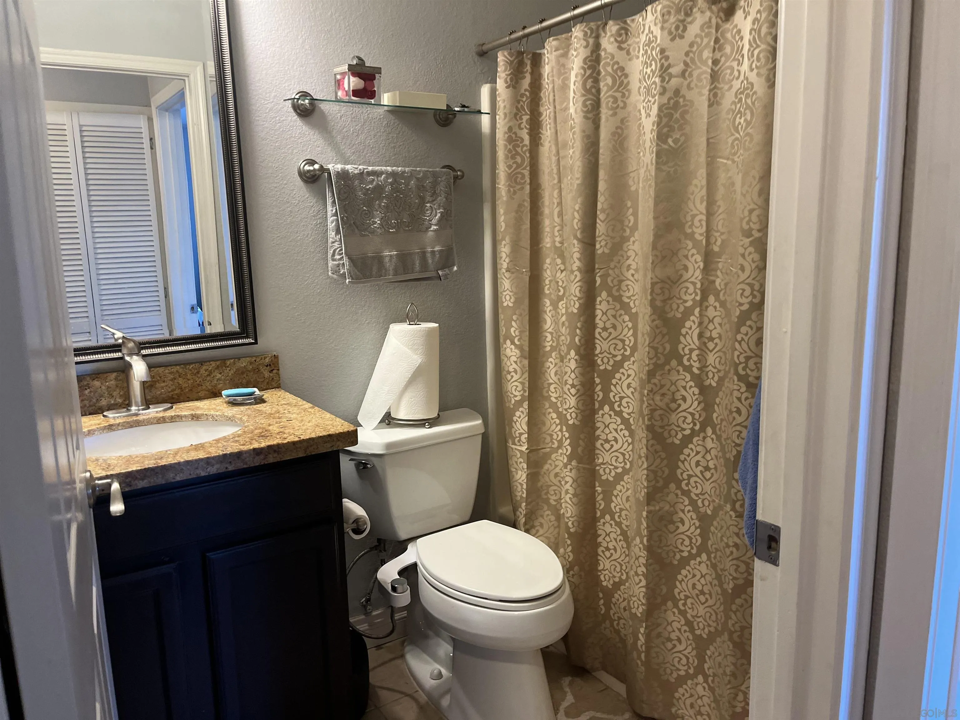9929 Azuaga Street, Unit F 202 San Diego, CA 92129 - Photo 17 of 18 a bathroom with a sink toilet and shower