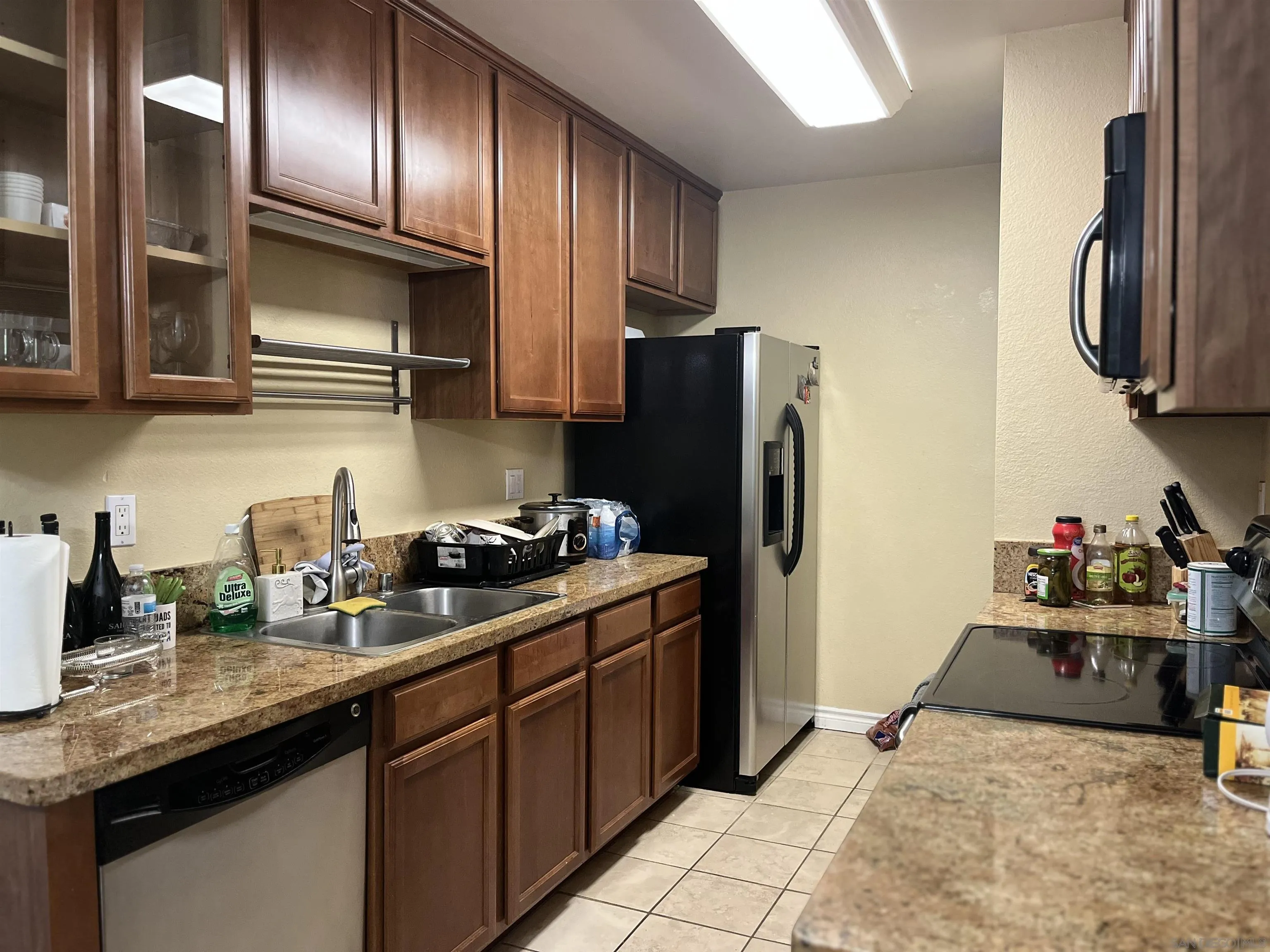 9929 Azuaga Street, Unit F 202 San Diego, CA 92129 - Photo 18 of 18 a kitchen with stainless steel appliances granite countertop a refrigerator stove and sink