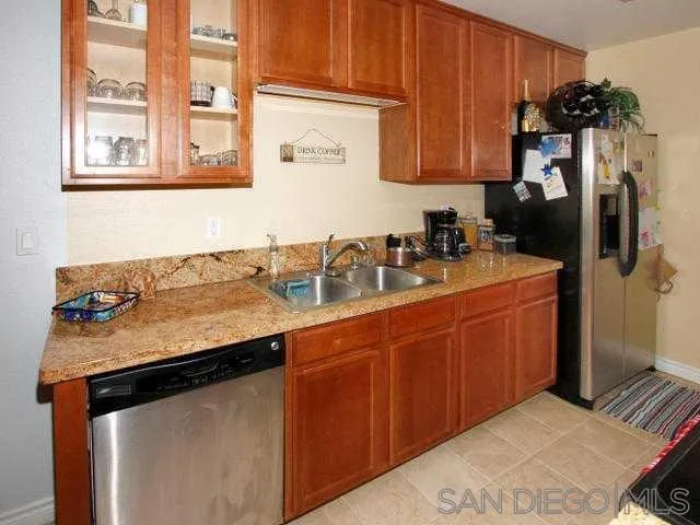 9929 Azuaga Street, Unit F 202 San Diego, CA 92129 - Photo 4 of 18 a kitchen with stainless steel appliances granite countertop a sink stove and refrigerator