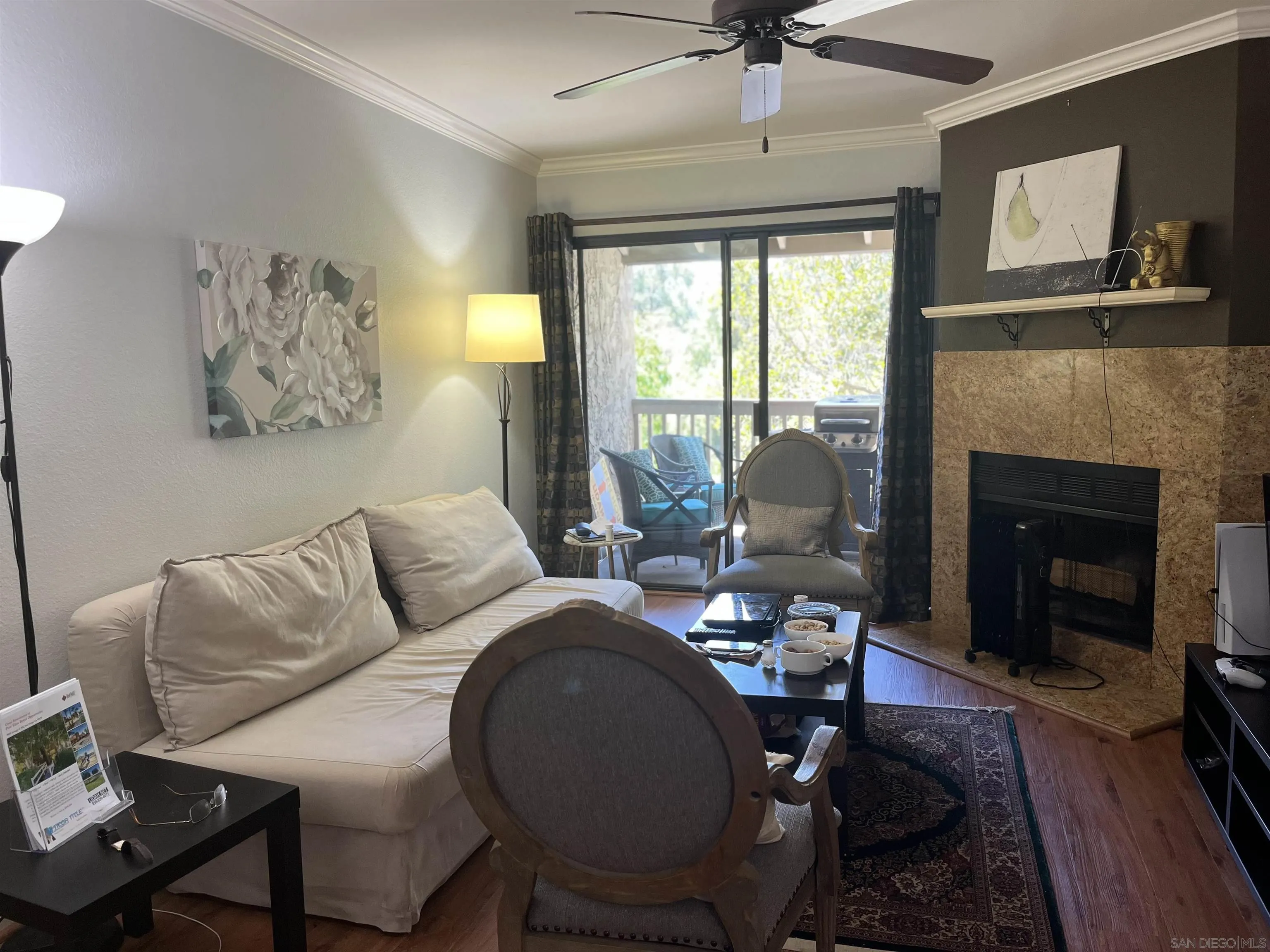 9929 Azuaga Street, Unit F 202 San Diego, CA 92129 - Photo 6 of 18 a living room with furniture a window and a fireplace