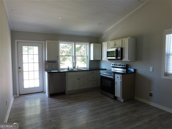 520 Old Athens Drive Nicholson, GA 30565 - Photo 8 of 13 a kitchen with stainless steel appliances a stove a sink a window and a window