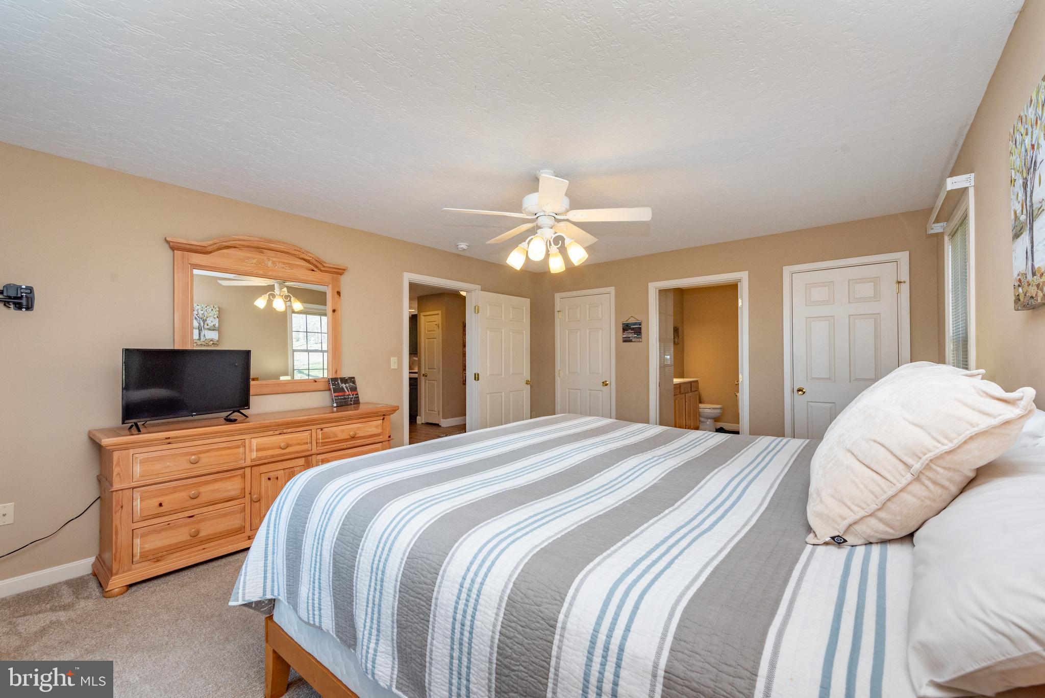 2828 Glendale Road Swanton, MD 21561 - Photo 24 of 78 a bedroom with a bed and a chandelier