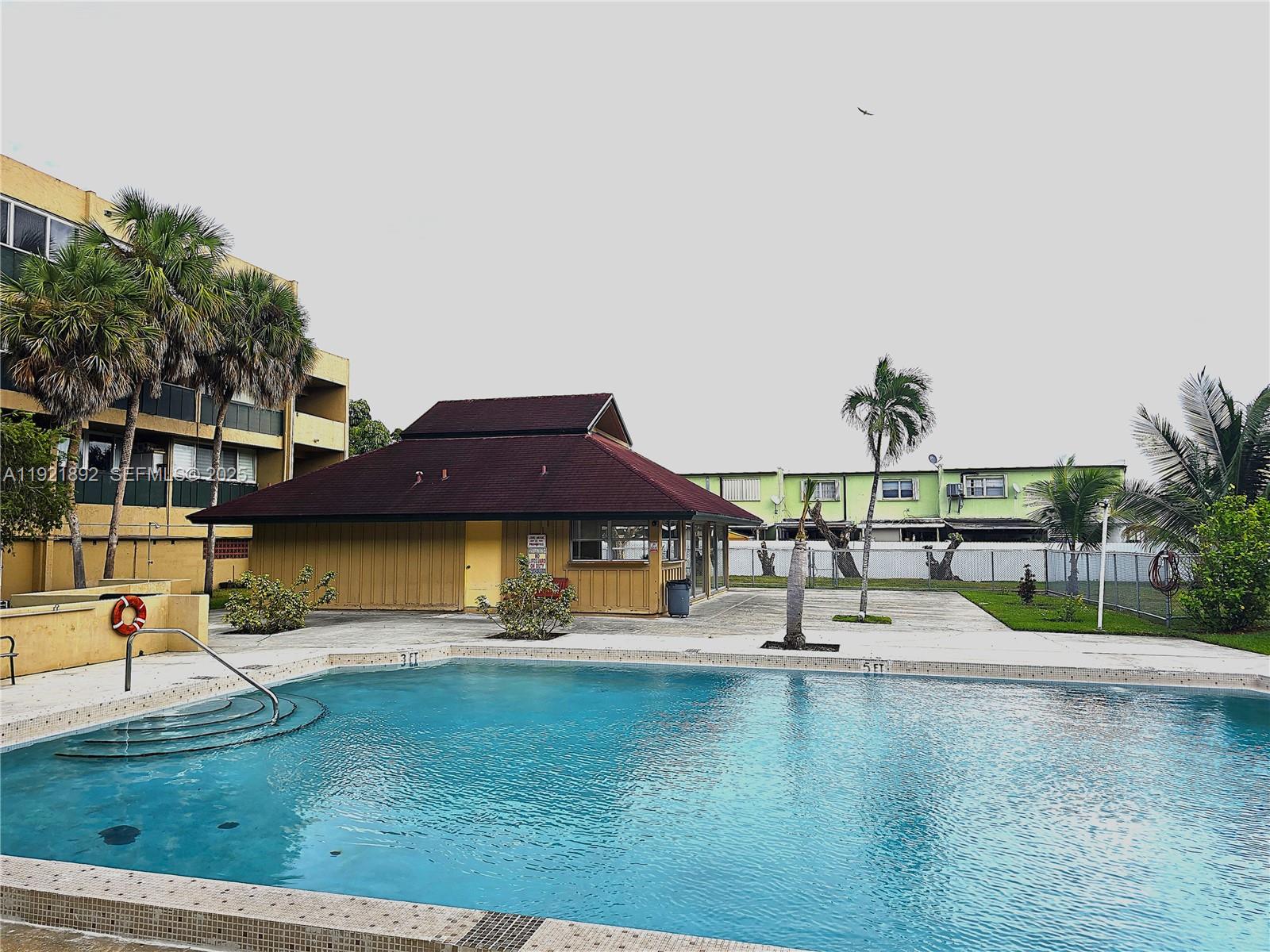 1750 West 56th Street, Unit 216 Hialeah, FL 33012 - Photo 11 of 14 a swimming pool with outdoor seating and yard