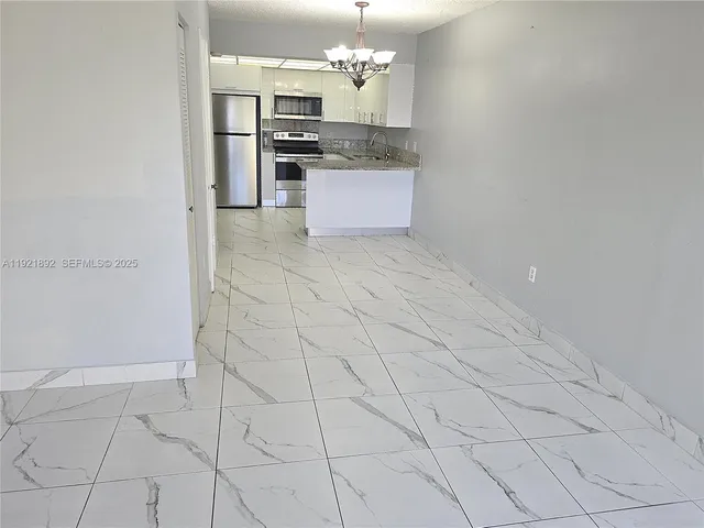 a kitchen with stainless steel appliances granite countertop a sink and cabinets
